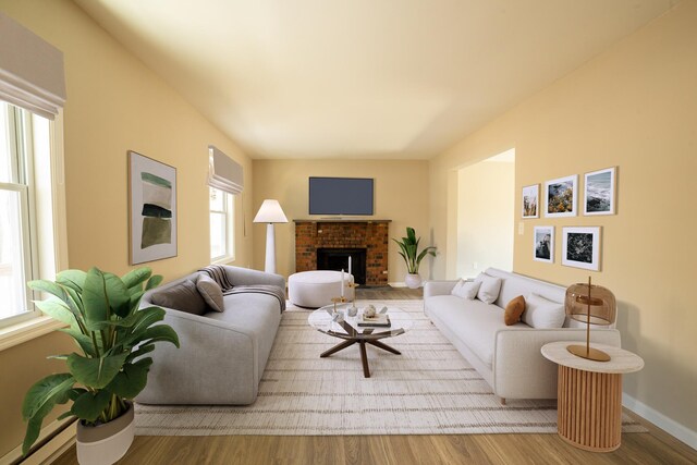 663 Sullivan Trl, Long Pond, PA 18334 - living room featuring wood finished floors, a brick fireplace, and baseboards