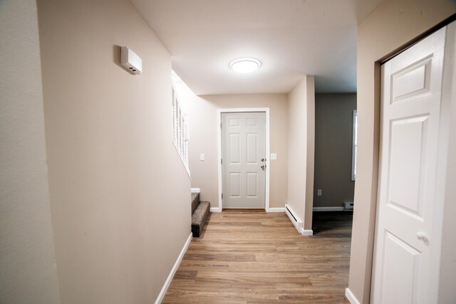 663 Sullivan Trl, Long Pond, PA 18334 - hall with light wood-style flooring, baseboards, stairs, and a baseboard heating unit