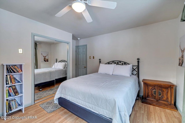 bedroom featuring ceiling fan, light wood-type flooring, and a closet