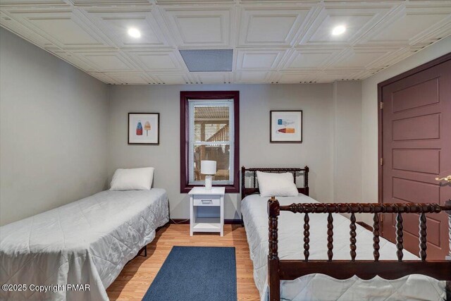 bedroom with ceiling fan and light hardwood / wood-style floors