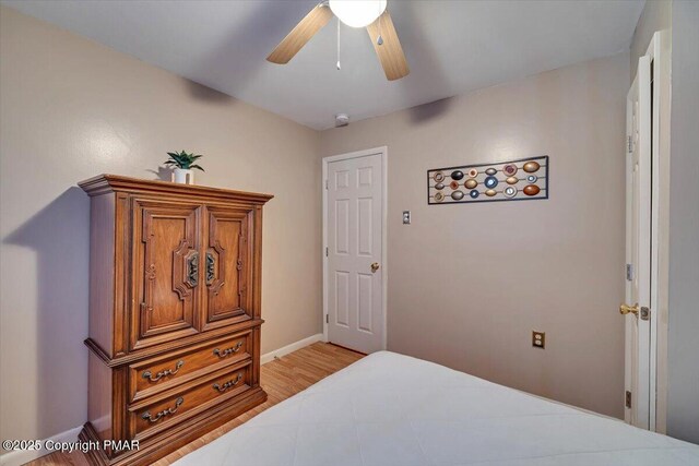 bedroom with ceiling fan and hardwood / wood-style floors