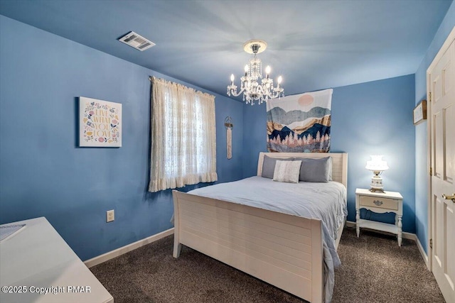 carpeted bedroom featuring a notable chandelier