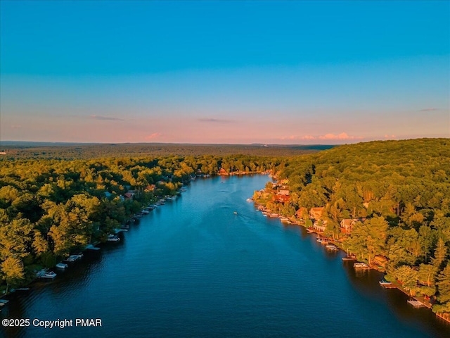 aerial view at dusk with a water view