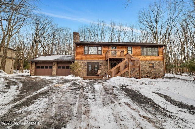 view of front of home featuring a garage and a deck