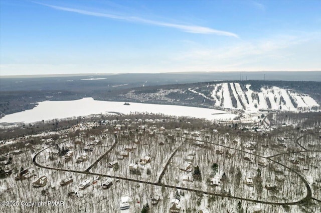 snowy aerial view with a mountain view