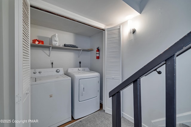 clothes washing area featuring washer and dryer and laundry area