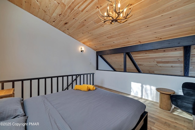 bedroom featuring lofted ceiling, wood finished floors, wood ceiling, and an inviting chandelier