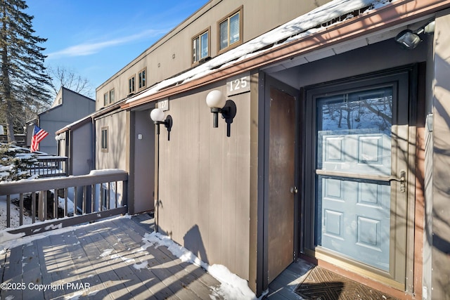 view of snow covered property entrance