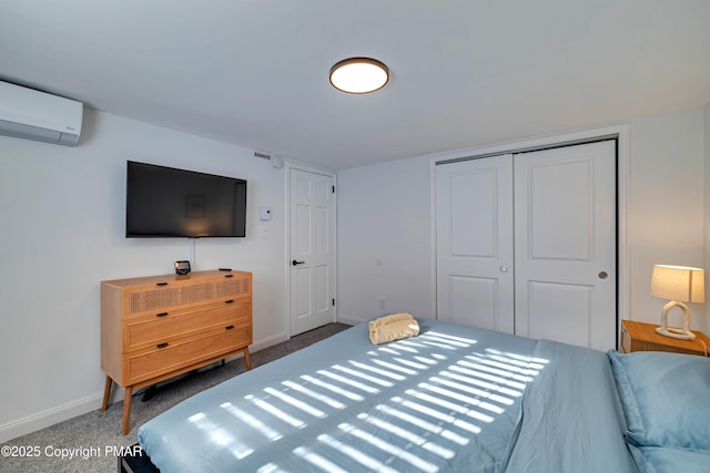 bedroom featuring a closet, an AC wall unit, and baseboards