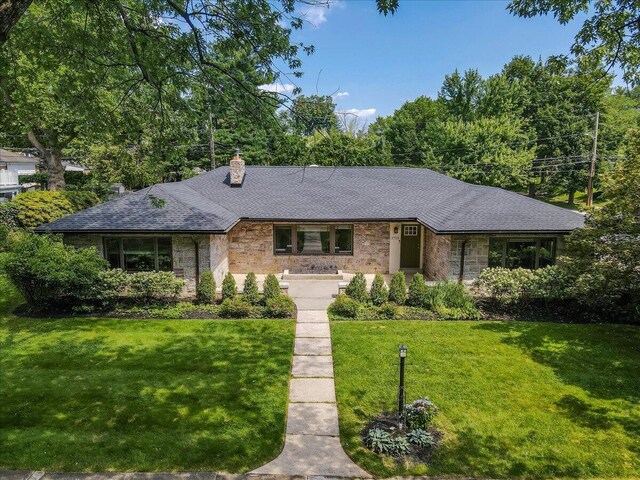2705 W Gordon St, Allentown, PA 18104 - single story home with stone siding, a chimney, a front yard, and a shingled roof