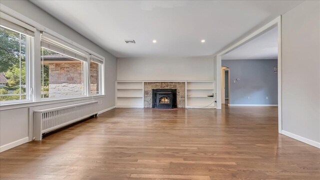 2705 W Gordon St, Allentown, PA 18104 - unfurnished living room with radiator heating unit, plenty of natural light, wood finished floors, and recessed lighting