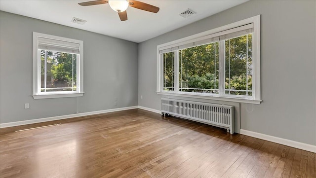 2705 W Gordon St, Allentown, PA 18104 - spare room featuring radiator heating unit, healthy amount of natural light, hardwood / wood-style floors, and ceiling fan