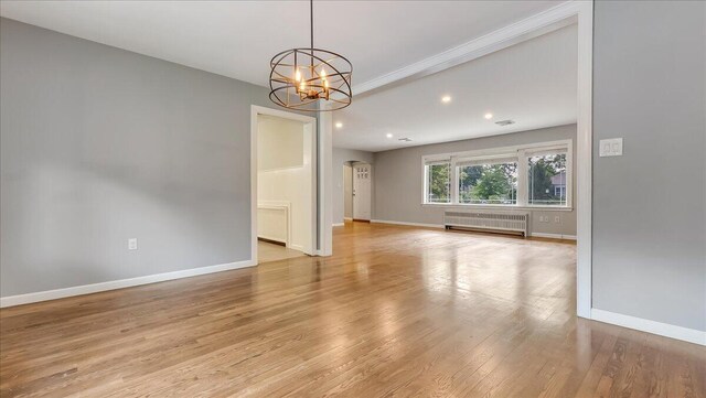 2705 W Gordon St, Allentown, PA 18104 - empty room with radiator heating unit, a chandelier, light wood-style floors, recessed lighting, and arched walkways