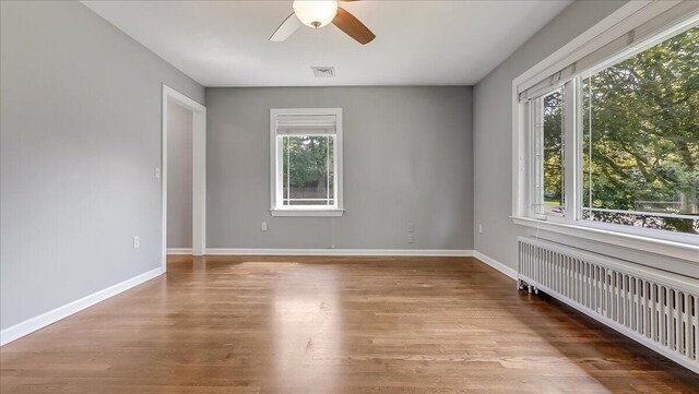 2705 W Gordon St, Allentown, PA 18104 - unfurnished room with radiator, plenty of natural light, ceiling fan, and wood finished floors