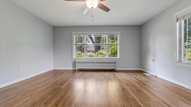 2705 W Gordon St, Allentown, PA 18104 - empty room with radiator heating unit, wood finished floors, and a ceiling fan