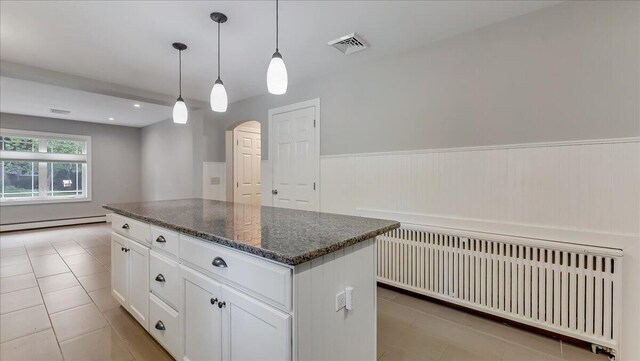 2705 W Gordon St, Allentown, PA 18104 - kitchen featuring radiator heating unit, a baseboard radiator, light tile patterned floors, arched walkways, and a wainscoted wall