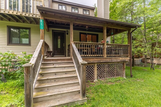 88 Wild Turkey Cir, Lake Ariel, PA 18436 - view of exterior entry featuring a chimney, a porch, and a lawn