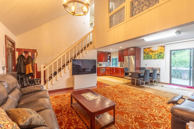 88 Wild Turkey Cir, Lake Ariel, PA 18436 - living area featuring high vaulted ceiling, stairs, and a chandelier