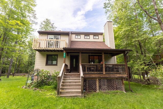 88 Wild Turkey Cir, Lake Ariel, PA 18436 - back of property with a chimney, covered porch, and a lawn