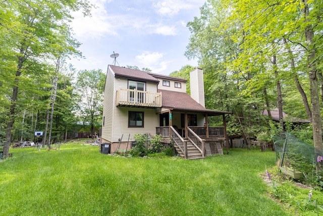 88 Wild Turkey Cir, Lake Ariel, PA 18436 - back of property featuring a chimney, a lawn, a porch, and stairs