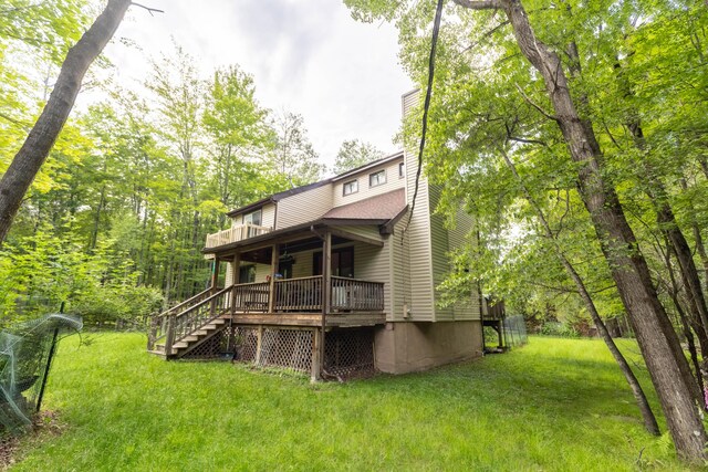 88 Wild Turkey Cir, Lake Ariel, PA 18436 - rear view of house featuring a chimney, a lawn, stairway, and a wooden deck