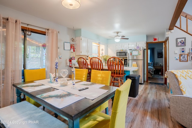 dining area featuring ceiling fan, a wealth of natural light, and light wood-style floors