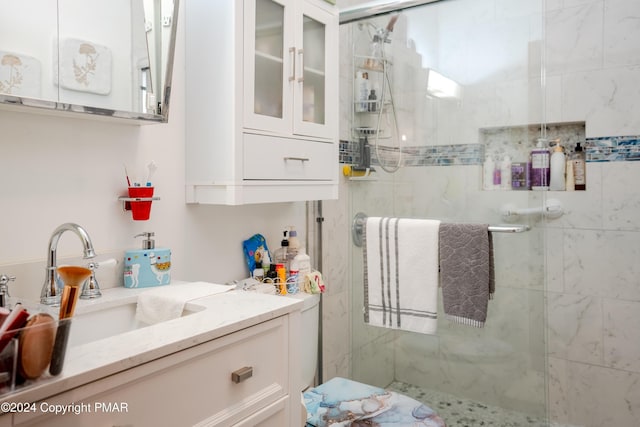 bathroom with a stall shower and vanity