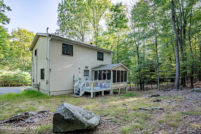 back of property featuring a sunroom