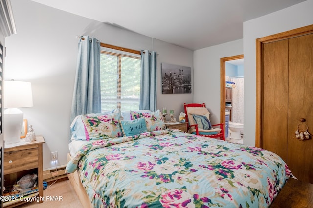 bedroom featuring a baseboard heating unit and a closet