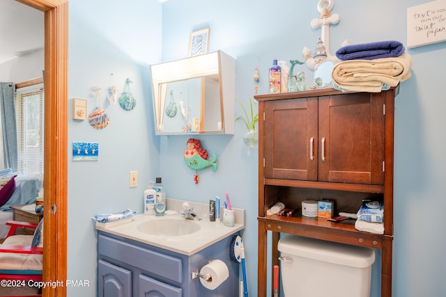 bathroom featuring connected bathroom, vanity, and toilet