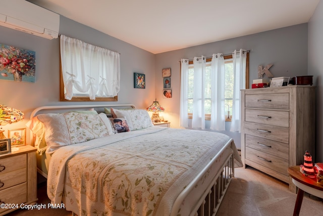 bedroom with carpet floors and a wall mounted air conditioner