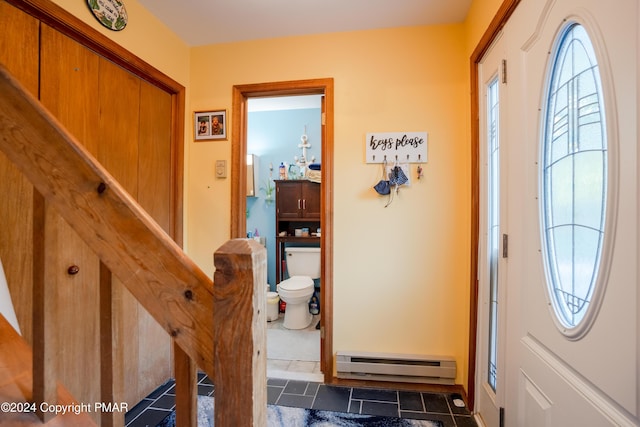 foyer entrance featuring baseboard heating and a wealth of natural light