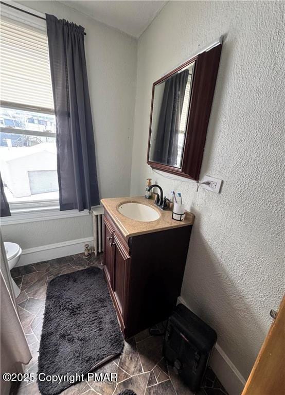 bathroom featuring vanity and toilet