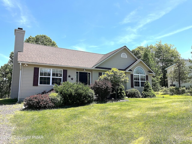 single story home featuring a shingled roof, a front lawn, and a chimney