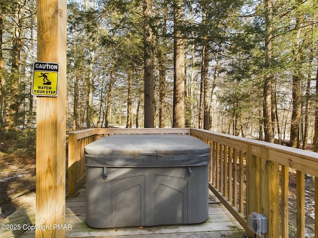 wooden deck featuring a hot tub