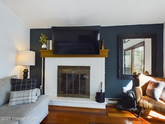 living room with a fireplace, wood-type flooring, and a textured ceiling