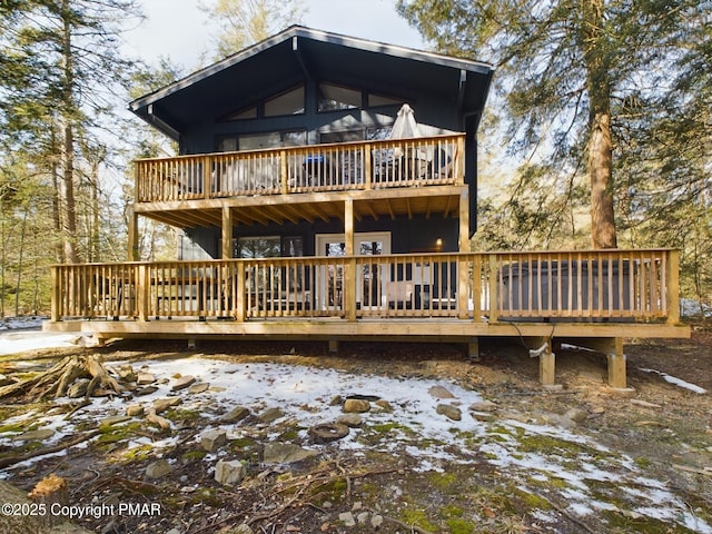 snow covered house with a deck