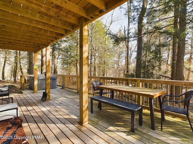 wooden deck with a hot tub