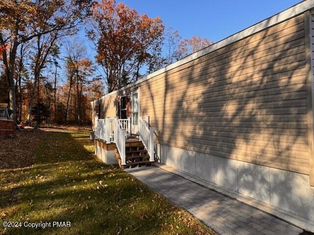 view of side of home featuring a yard