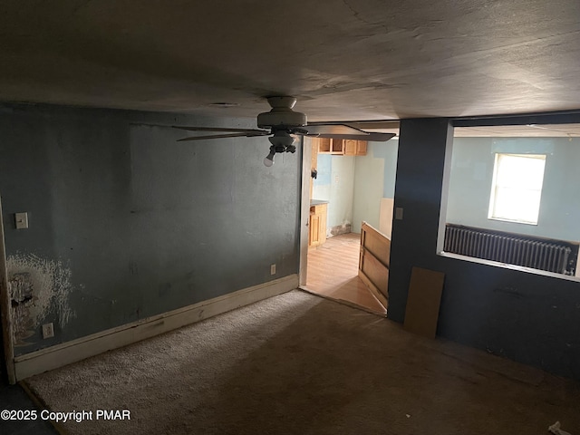 spare room with ceiling fan and carpet flooring