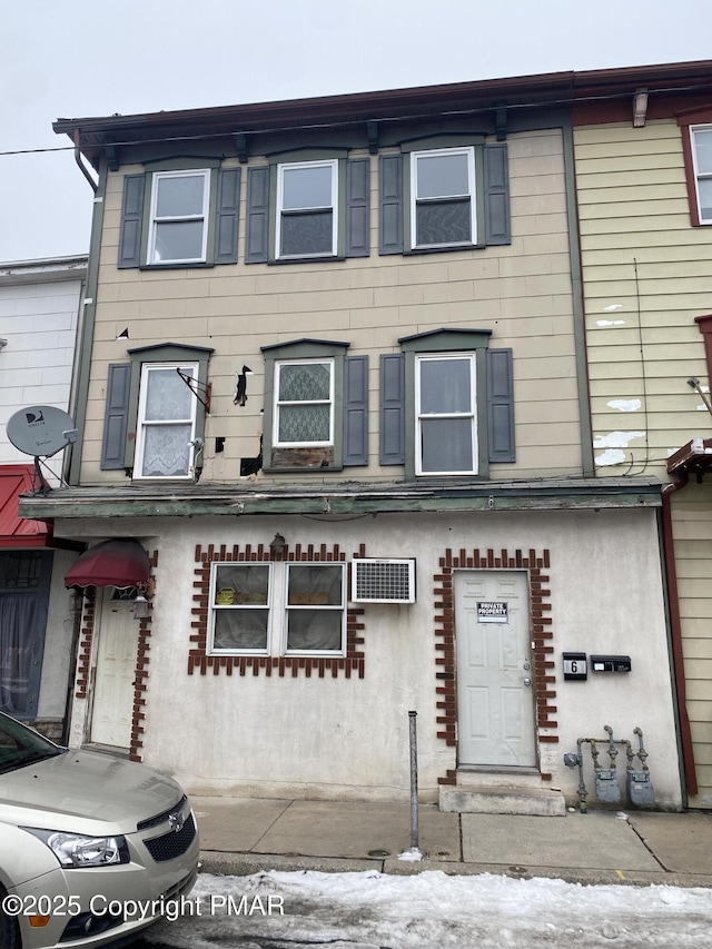 view of property with a wall mounted AC