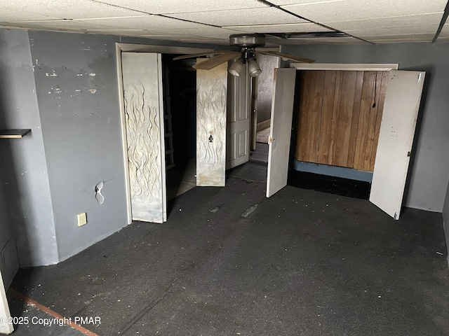 basement featuring a paneled ceiling