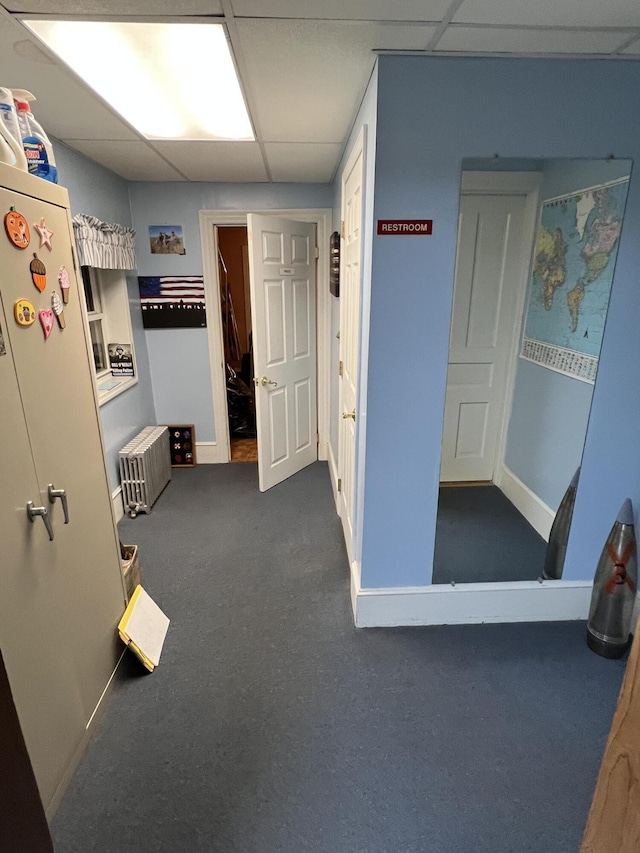233 W Broad St, Tamaqua, PA 18252 - hall with radiator, a paneled ceiling, and dark carpet