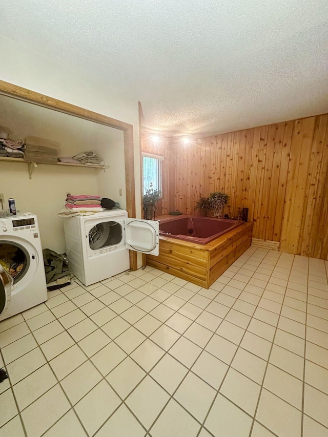 207 Manchester Dr, Bushkill, PA 18324 - laundry room with independent washer and dryer, a textured ceiling, wood walls, and light tile patterned floors