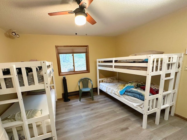 207 Manchester Dr, Bushkill, PA 18324 - bedroom with wood finished floors, a textured ceiling, ceiling fan, and baseboards