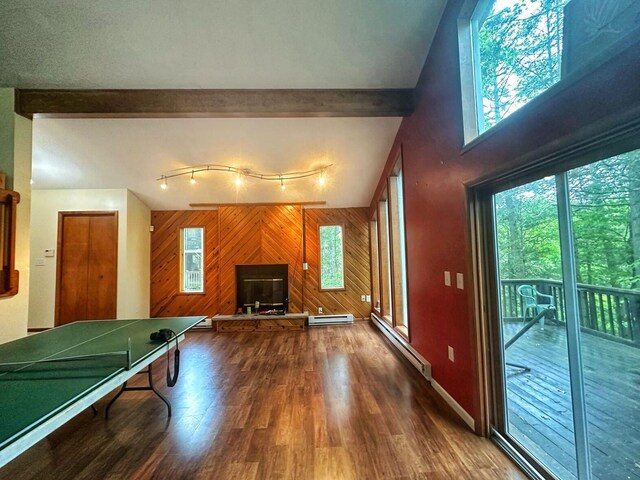 207 Manchester Dr, Bushkill, PA 18324 - recreation room with wood walls, a baseboard heating unit, wood finished floors, baseboards, and a high ceiling