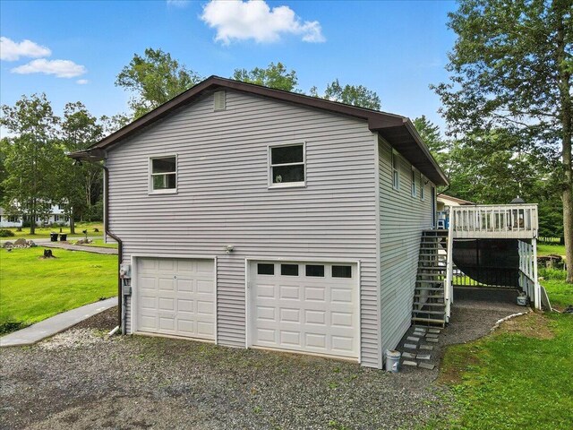 52 Bull Pine Rd, East Stroudsburg, PA 18301 - view of side of property with stairs, a deck, an attached garage, a yard, and gravel driveway