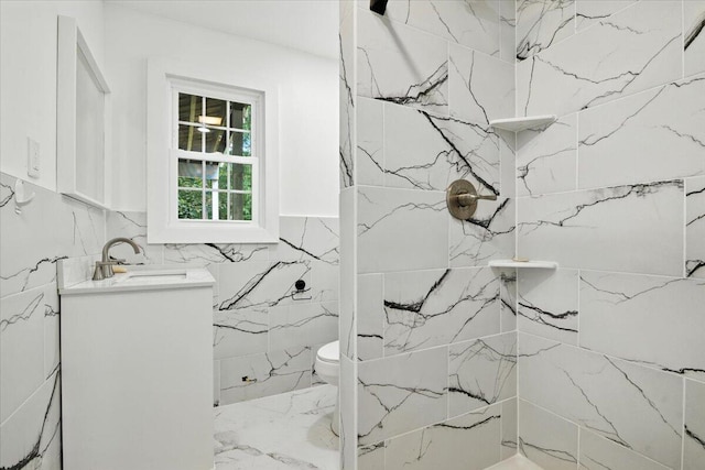 52 Bull Pine Rd, East Stroudsburg, PA 18301 - bathroom with vanity, a marble finish shower, marble finish flooring, and tile walls