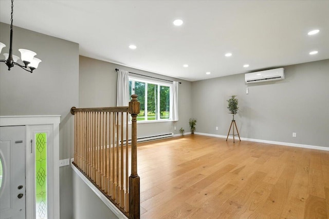 52 Bull Pine Rd, East Stroudsburg, PA 18301 - unfurnished room with a wall unit AC, light wood-style flooring, a baseboard heating unit, recessed lighting, and a chandelier