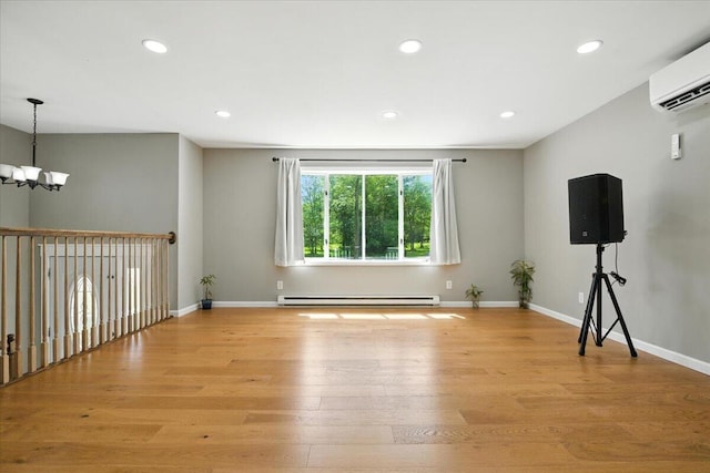 52 Bull Pine Rd, East Stroudsburg, PA 18301 - empty room with a baseboard heating unit, a wall mounted AC, a chandelier, light wood-type flooring, and recessed lighting